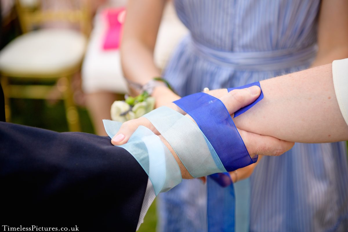 Hand fasting ceremony, humanist wedding, symbolic wedding gestures, sand blending